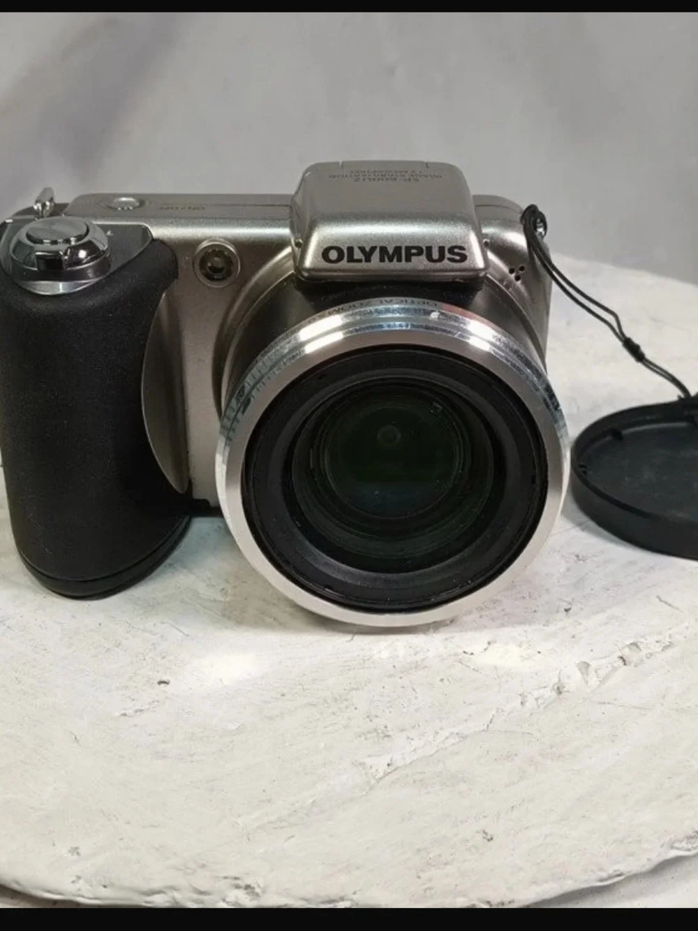 Olympus Silver Digital Camera with Black Grip and Lens Cap